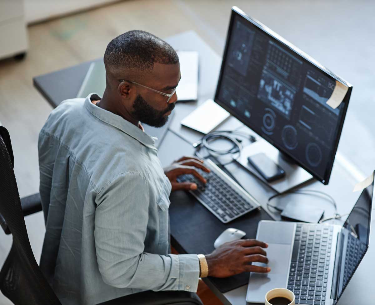 man at work, using two monitors