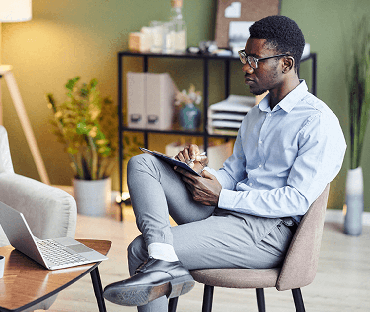 Man on his tablet and laptop