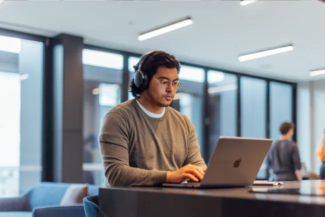 Man with headphones on his laptop